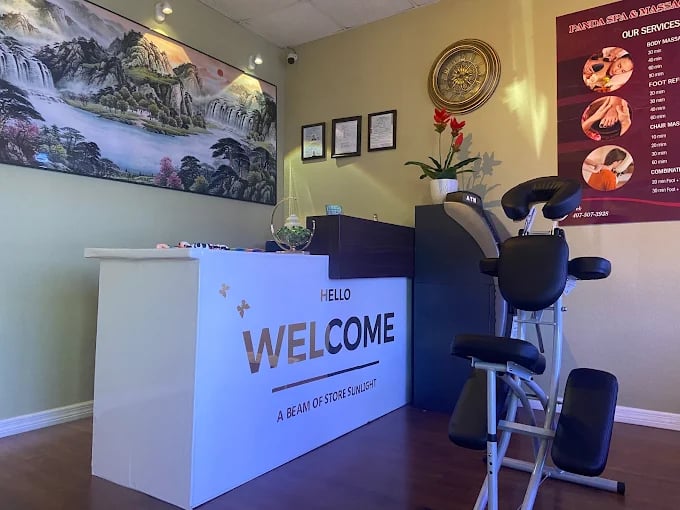 Massage chair and welcome desk in serene spa with mountain landscape painting